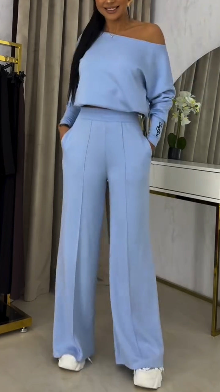 Női kosztüm laza, váll nélküli blúzzal és lezser nadrággal